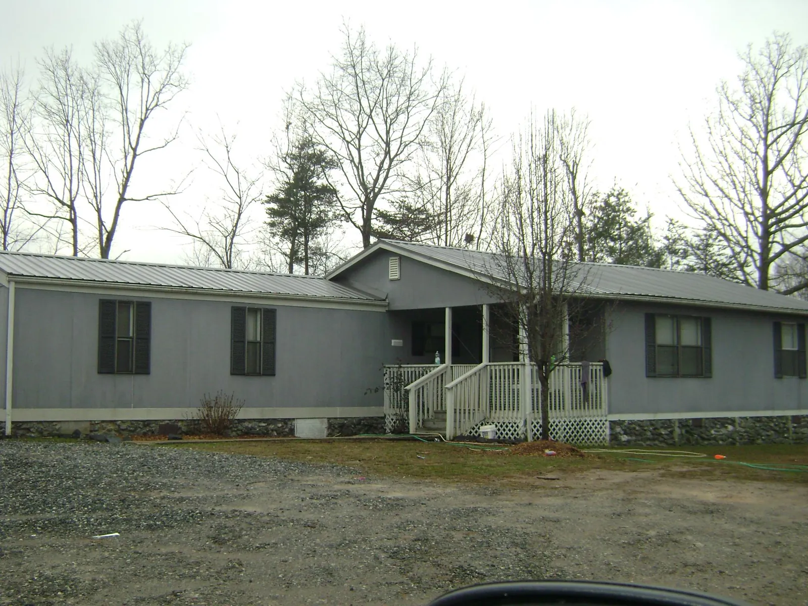 Metal roof over a manufactured home with a covered front porch in Canal Fulton